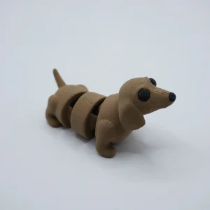 Perrito salchicha articulado impreso en 3D en PLA+ café, cuerpo segmentado y cola móvil