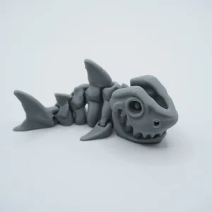 iburón articulado impreso en 3D en PLA+ gris, cuerpo segmentado y aleta dorsal